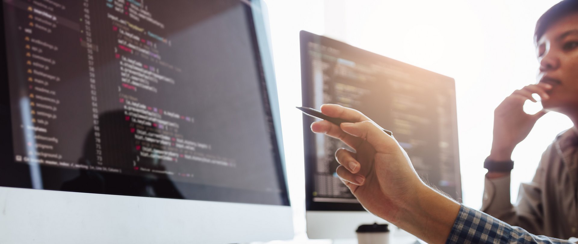 Developing programming and coding technologies working in a software engineers developing applications together in office.